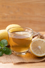 Lemon and ginger tea in cup glass with mint leaf, Healthy hot drink