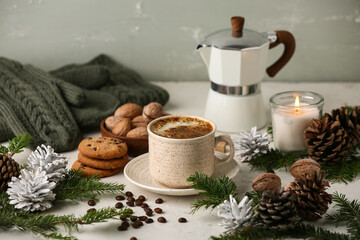 Winter composition with mug of coffee, cezve, cookies, nuts and fir branches on white background