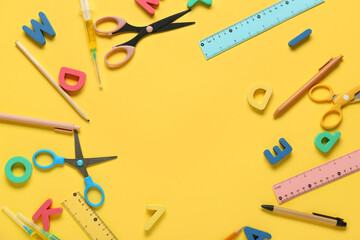 Frame made of letters with stationery on yellow background. Nobel Prize Day