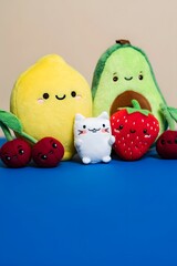 Cute fruit and cat plushies on a blue surface, arranged in a playful and colorful display