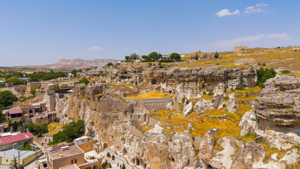 Urgup, Nevsehir, Turkey. Close up to wide shot of abandoned rock dwellings with detailed stone fence in Cappadocia landscape.. Aerial View