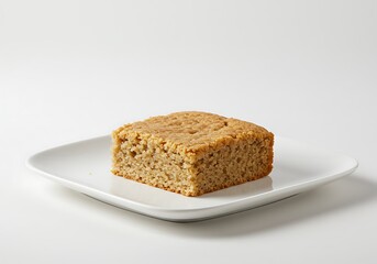 Square slice of baked dessert on a white plate with copy space