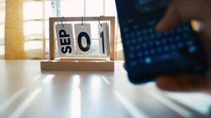 September 1st Wooden Desk Calendar with Smartphone - Powered by Adobe