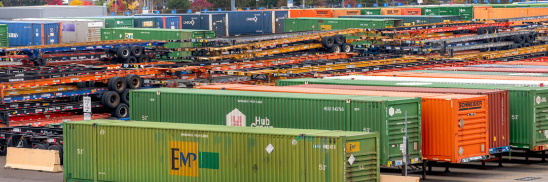Panoramic view of many semi truck containers and container chassis at logistic hub in Portland, Oregon.