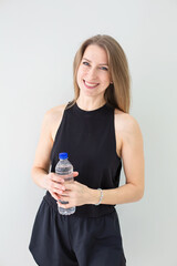 Smiling Woman with Water Bottle After Workout