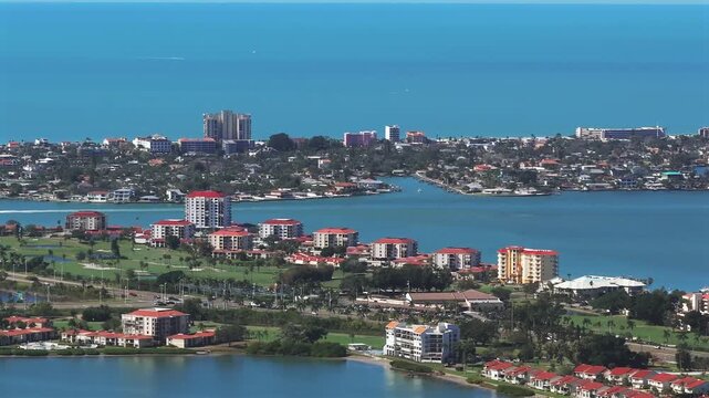 Constant Aerial Panning View of Pass-a-Grille Beach, and iconic Don CeSar Hotel along the connecting waterfront communities, featuring golf courses, condos, in Saint Petersburg, Florida's Gulf Coast.