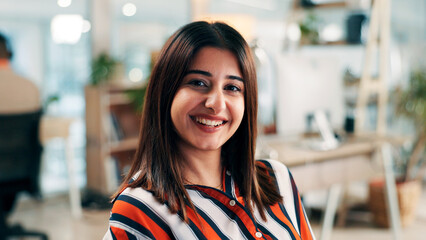 Business woman, portrait and smile at office for professional mission, about us and creative worker at startup. Female person, happy and confident with ambition for career opportunity at media agency