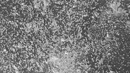 Monotone aerial view of swirling foam patterns on river surface