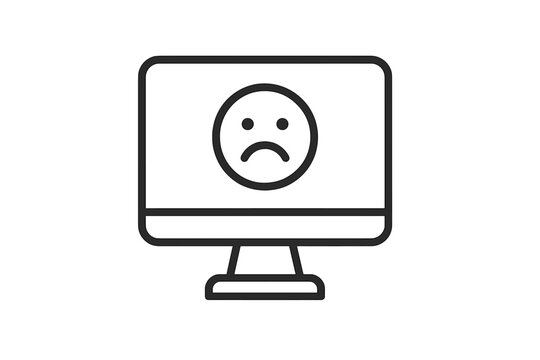 Desktop computer screen displaying a sad face icon symbolizing system error or failure