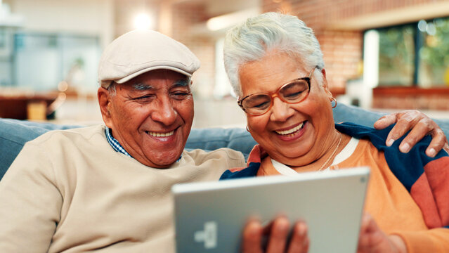 Sofa, home and old couple on tablet laugh for online streaming, internet subscription or bonding. Retirement, marriage and mature man and woman on digital tech for videos, watching movie and relax - Powered by Adobe