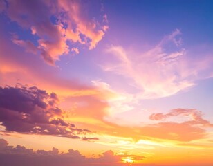 Obraz premium Vivid sunset featuring a brilliant display of color. Wispy clouds are highlighted by golden hues, blending with purple and blue tones