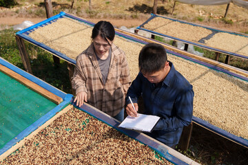 People inspect the roasting of coffee beans in large metal vats, which are a blend of Arabica and Robusta coffee beans to produce high-quality coffee with excellent taste.