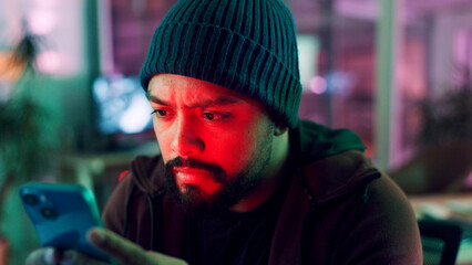 Night, hacker and man with cellphone, internet and connection with cybersecurity programming. Person, online crime or install malware code with smartphone, website server or app for database software