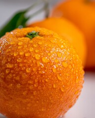 An ultra close-up macro shot showcases a fresh red grape with a dewy surface, accentuated by water droplets, in high detail food photography