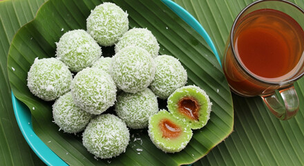 "Traditional Klepon: Indonesian Sweet Rice Cake with Palm Sugar Filling and Coconut Coating"
