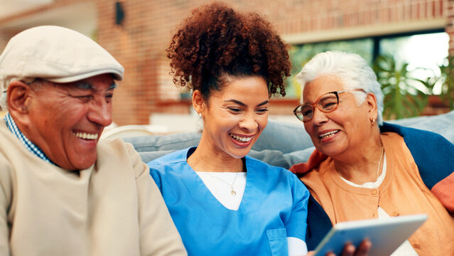 Happy, tablet and nurse with old couple in home for talking, conversation and online website. Retirement, assisted living and caregiver, man and woman on tech for connection, social media and bonding - Powered by Adobe