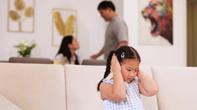 Young Girl Covers Ears During Parents&acirc; Argument at Home