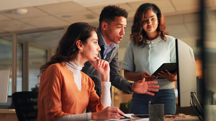 Computer, discussion and business people in office at night with creative project in collaboration. Review, technology and manager with magazine editors for advice on article for publishing deadline.