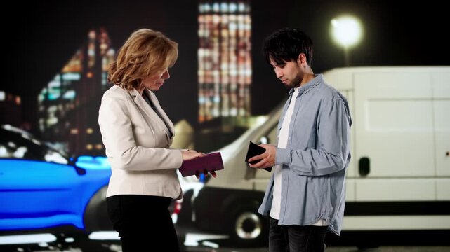 Drivers Calmly Exchanging Insurance Information After Car Accident