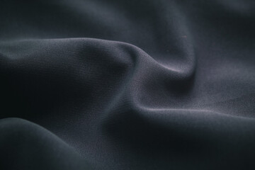 dark colored fabric texture with fine folds and a soft surface