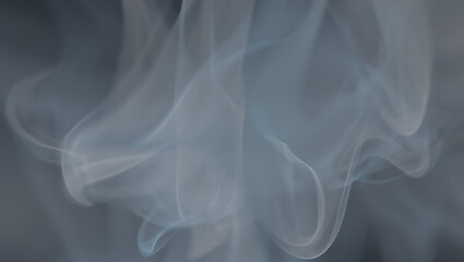 Obraz premium A soft, ethereal image of delicate grey smoke swirling on a neutral background.
