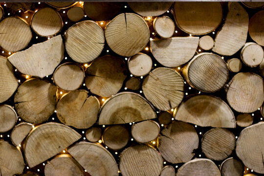 stack of firewood Shows stacked wooden logs. Full-frame composition, brown-beige tone. Realistic style, nature background