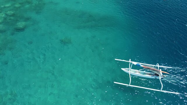 Aerial Of Fishing Boat Arriving At Amed Beach Over Clear Turquoise Water