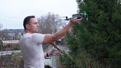 A man repairs drones at home. Working on quadcopters. Landing on a hand after a flight.