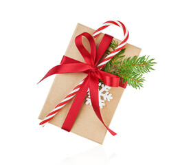 Christmas gift box wrapped in craft paper decorated with candy red cane in white stripes and fir...