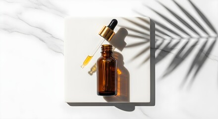 Amber dropper bottle with serum casting a shadow on a marble surface with palm leaf shadow.