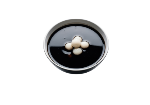 Closeup of pills in a black container lid.