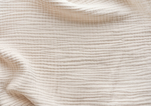 Muslin fabric texture. Background of light gray muslin fabric. Cream color muslin background close up. Design element.