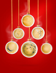 Christmas tree arrangement formed from cups of aromatic coffee in form of Christmas tree ornaments hung on golden ribbons on deep beautiful red background. Modern holiday  Christmas composition.