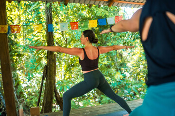 Woman practicing warrior pose during yoga session