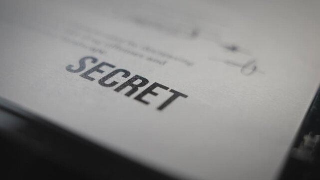 Close up on classified document labeled as Secret being photocopied or scanned. Digital copy of sensitive information of government spy surveillance agency. Top secret confidential file exposed