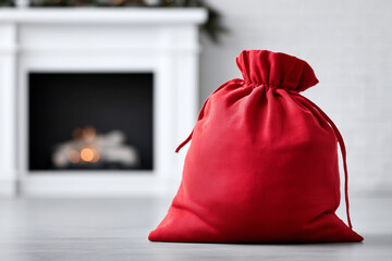 Santas sack placed perfectly beside a fireplace, photographed like a commercial product display, soft backlight and clean shadows, with copy space