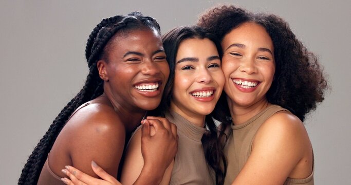 Happy women, portrait or hug with beauty, diversity or skin tone for cosmetics on studio background. Female people, inclusion or multiracial group with smile for skincare, health or wellness in salon