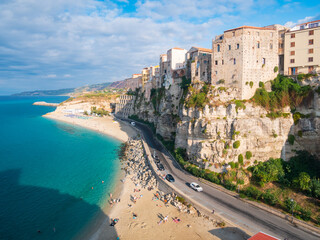Tropea Calabria Italy. Cliffside town above turquoise sea, sunny beach, historic buildings on limestone, vibrant summer colors.