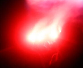 A red car with its headlights on