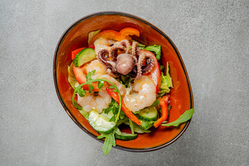 Fresh shrimp and tender octopus resting on a bed of crisp greens and colorful vegetables