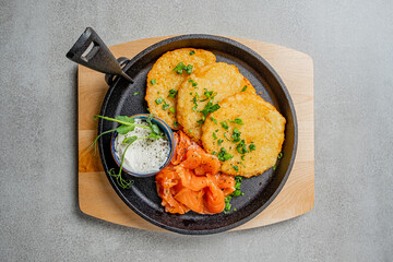 Golden potato pancakes paired with smoked salmon and a creamy sauce, perfect for any meal