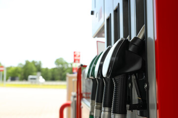 Fototapeta premium Fuel nozzles are ready for vehicles to refuel at the station