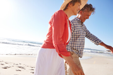 Walking, couple and laugh on vacation, beach and romance on getaway, mockup space and people on date. Outdoor, mature man and bonding with woman on holiday, marriage and anniversary in nature or sea