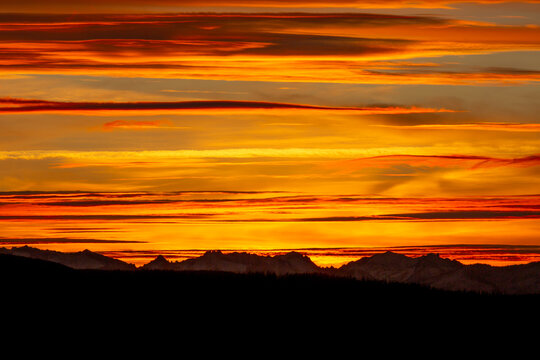 A brilliant sunset over a mountain range.
