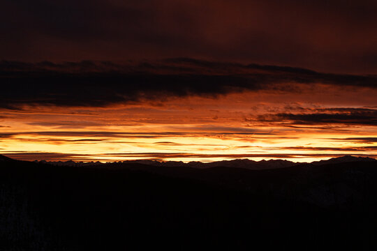 The sun sets in the distance over the Bitterroot Mountains