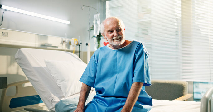 Thinking, patient and senior man in hospital, healthcare and happy for recovery on bed or treatment. Rehabilitation, health and old person with smile for discharge, reflection and wellness in clinic