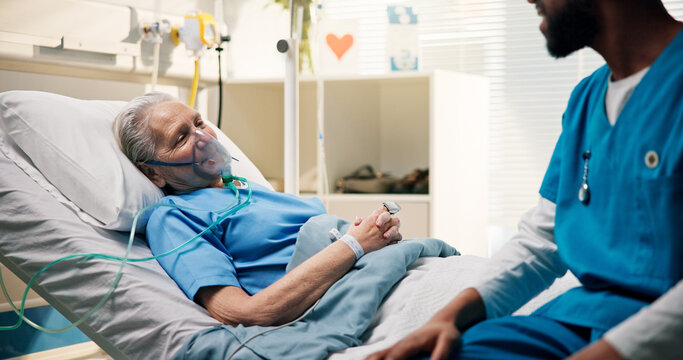 Nurse, conversation and senior woman in hospital bed for recovery, news or medical feedback. Elderly patient, oxygen mask and professional with discussion for progress, test results or health support