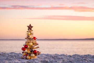 Driftwood Christmas tree adorned with a star, baubles and fairy lights