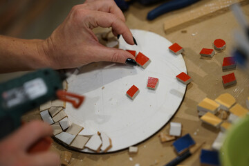 Making mosaic during artistic workshop. 