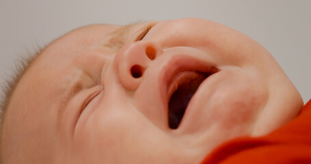 Upset baby crying and throwing a tantrum mother calms him down. Baby boy annoyed by something...